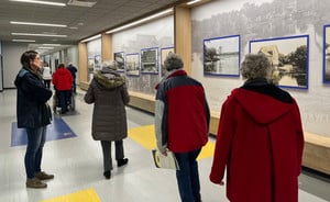 Community members look at the murals at West Side.