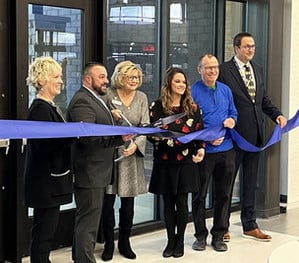 School Board Members and Superintendent Heesch hold the ribbon for the ribbon cutting.