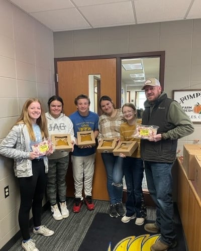 OMS Student Leadership Council receiving pies for their Thanksgiving dinners for families in need.