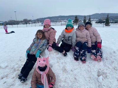 3rd students playing outside in the snow.
