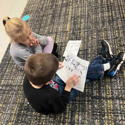 Kindergarteners reading books.