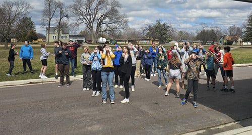 Olson Middle School students and staff took advantage of partly sunny skies to view the eclipse.