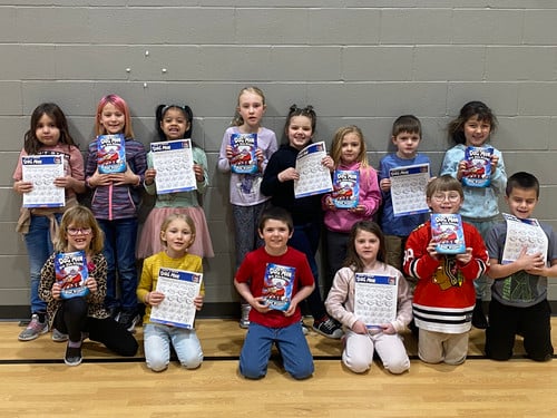 Students receive a Dog Man book.