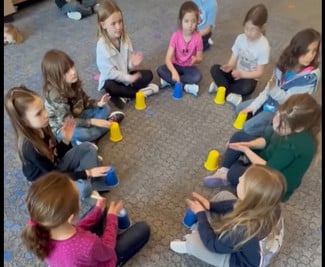West Side 2nd Graders participate in making music with cups.