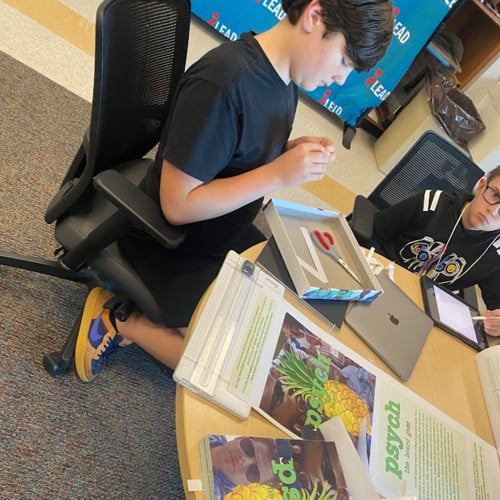 iLEAD student getting crafty with the Psych board game.