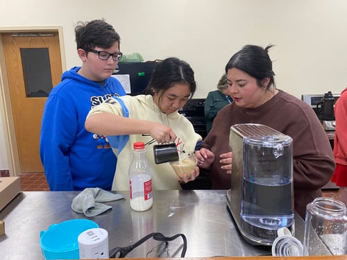 iLEAD students learn latte art through a demonstration.