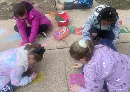 Lyndon Station Elementary students doing sidewalk art.