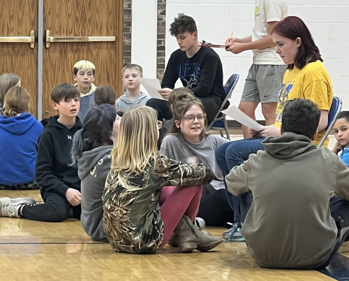 The 8th grade WEB Team facilitates a trivia activity.