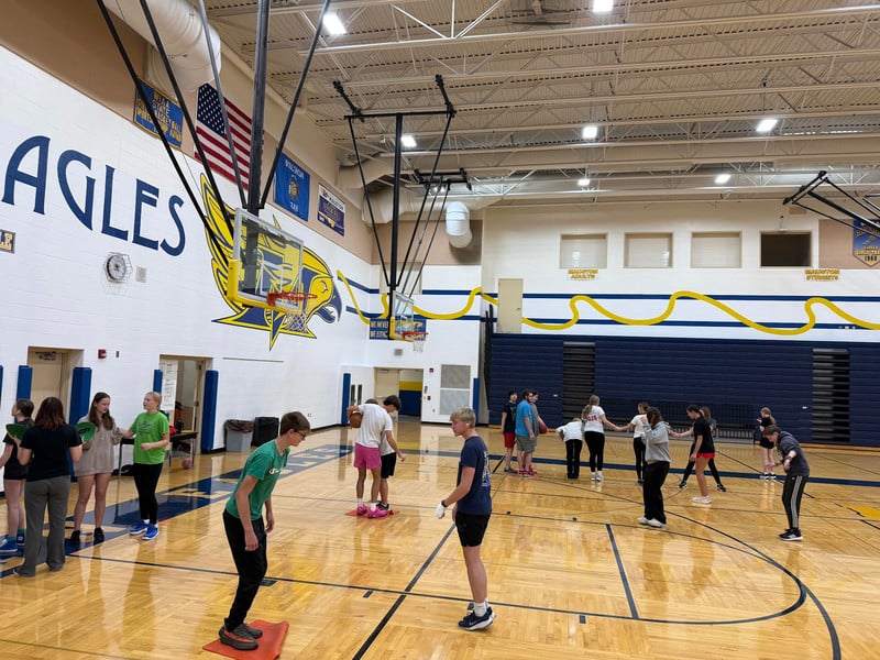 Students are in a gymnasium.