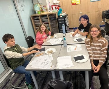 Students explored worm experiments in a classroom.