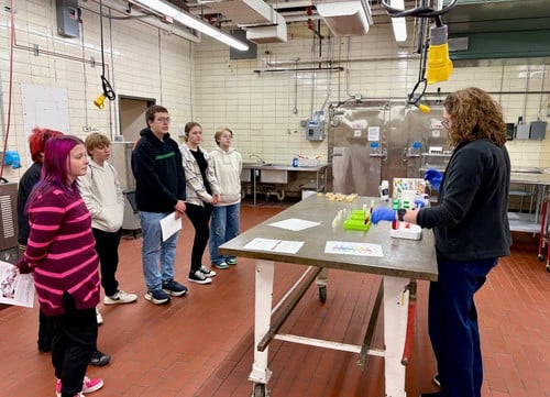 Students look at a presenter in a lab at UW-Madison.