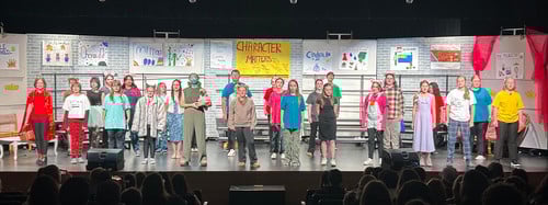 Students are on stage for a performance.