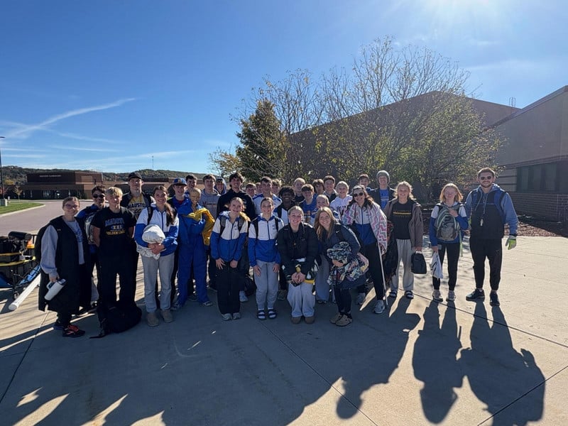 Cross Country team poses for a picture outside the schools.